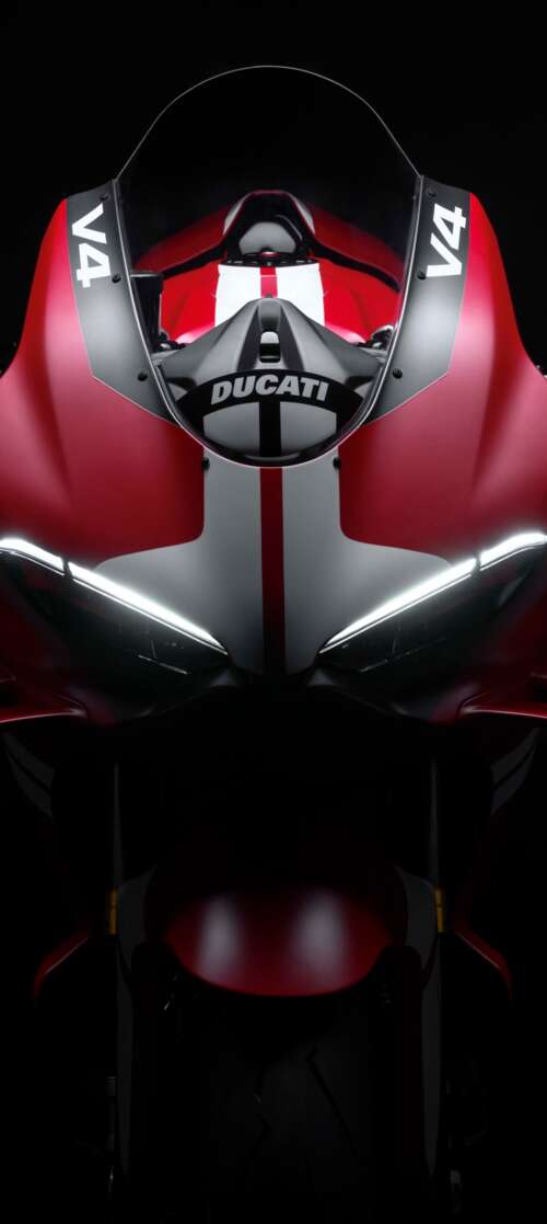 Cinematic close-up of a Ducati Superleggera V4 Centenario sports bike in a dark studio... Infinix Smart 10 free background images