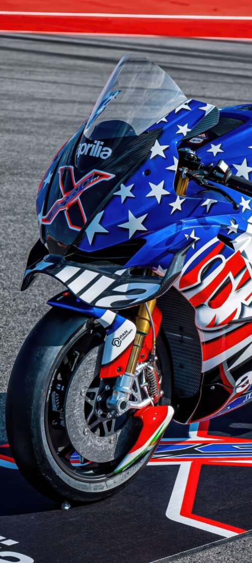 Advanced MotoGP racing motorcycles speeding through a corner on a professional circuit... Vivo iQOO Z10 Turbo