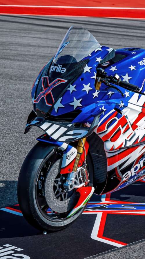 Advanced MotoGP racing motorcycles speeding through a corner on a professional circuit... Apple iPhone SE 2022 cell phone backgrounds free