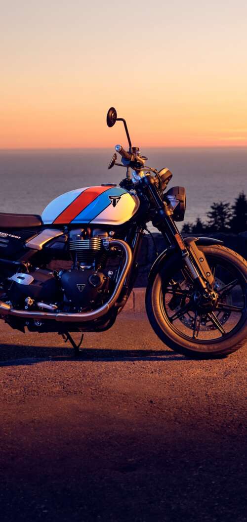 A modern 2025 motorcycle parked against a vibrant sunset sky with warm orange and... Oppo A6k 4G free background images