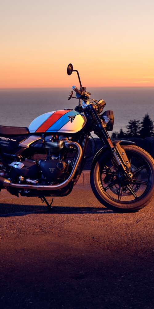 A modern 2025 motorcycle parked against a vibrant sunset sky with warm orange and... Ulefone Rugking 2 Pro pictures for wallpaper