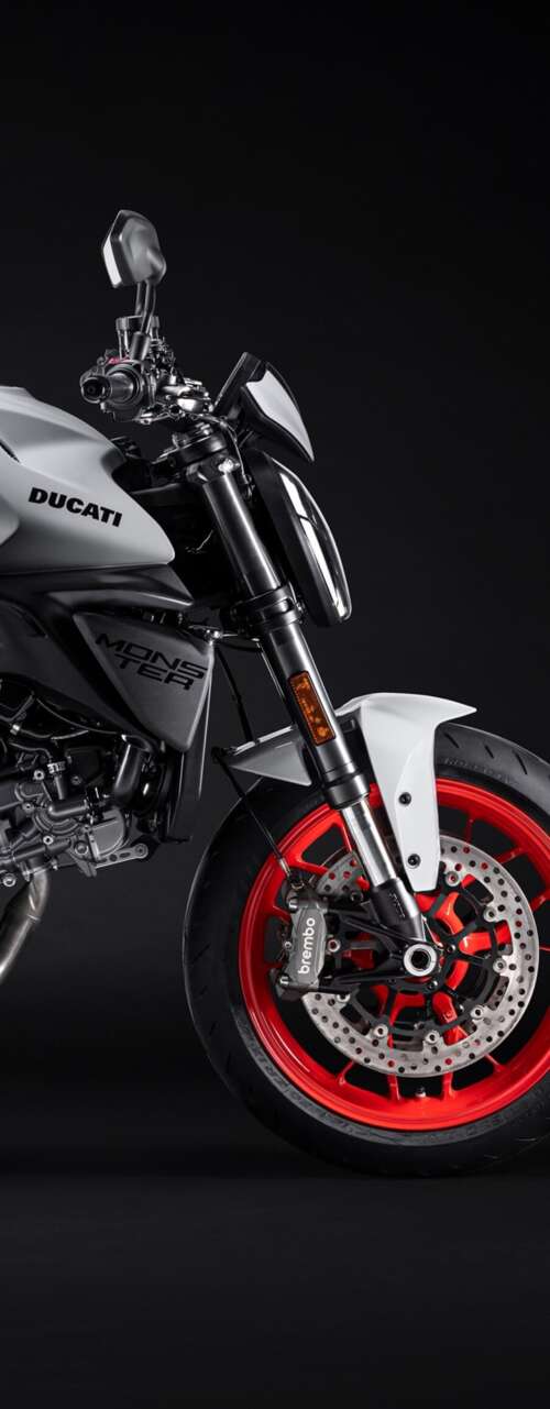 A high-resolution, cinematic close-up of a 2026 Ducati Monster V2 motorcycle set... wallpapers for android