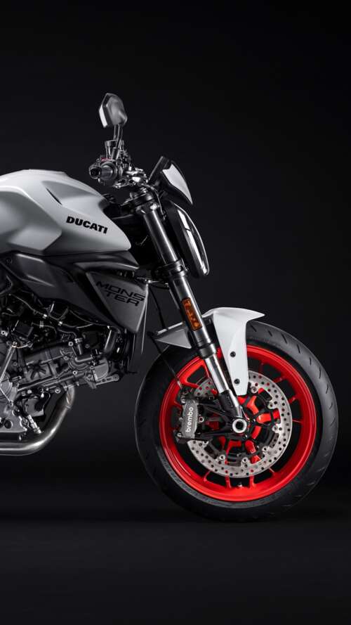 A high-resolution, cinematic close-up of a 2026 Ducati Monster V2 motorcycle set... Apple iPhone SE 2022 free wallpaper