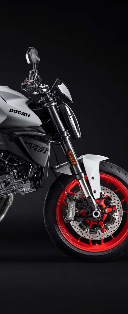 A high-resolution, cinematic close-up of a 2026 Ducati Monster V2 motorcycle set... Samsung Galaxy Z Flip7 FE hand phone wallpaper