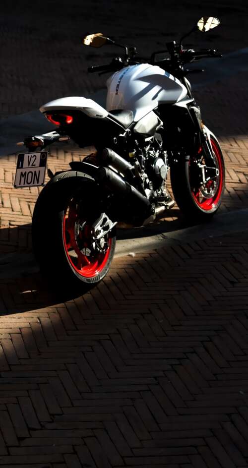 A sleek and futuristic 2026 Ducati Monster V2 sports motorcycle in a high-quality... Sharp Aquos C10 wallpaper images