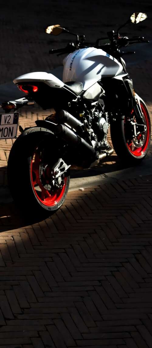 A sleek and futuristic 2026 Ducati Monster V2 sports motorcycle in a high-quality... Xiaomi Redmi 14C 5G free wallpaper