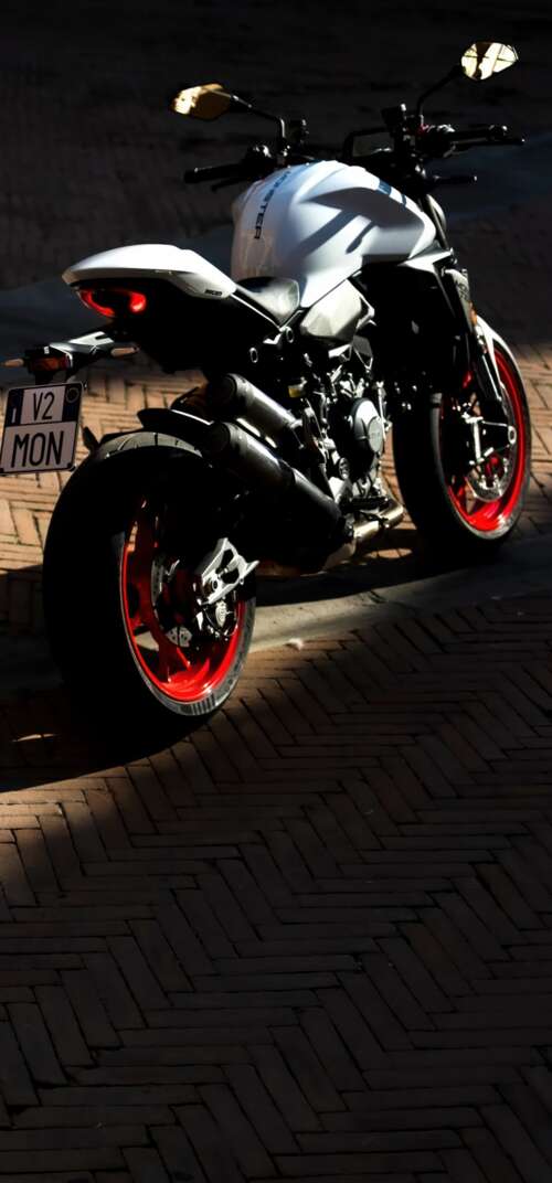 A sleek and futuristic 2026 Ducati Monster V2 sports motorcycle in a high-quality... Samsung Galaxy S26 Ultra high definition wallpaper