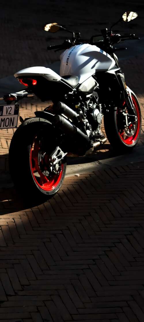 A sleek and futuristic 2026 Ducati Monster V2 sports motorcycle in a high-quality... itel CITY 100 wallpaper photo gallery download