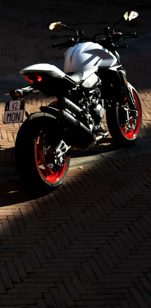 A sleek and futuristic 2026 Ducati Monster V2 sports motorcycle in a high-quality... Huawei Mate 30 Pro wallpaper images