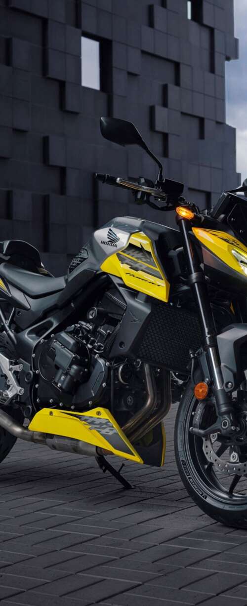 A modern 2026 Honda CB750 Hornet motorcycle parked outdoors in a contemporary landscape. high definition wallpaper