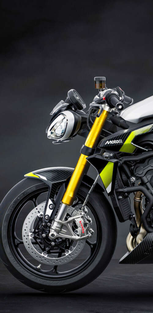 A high-performance 2026 Triumph Street Triple 765 Moto2 Edition motorcycle set against... free background images