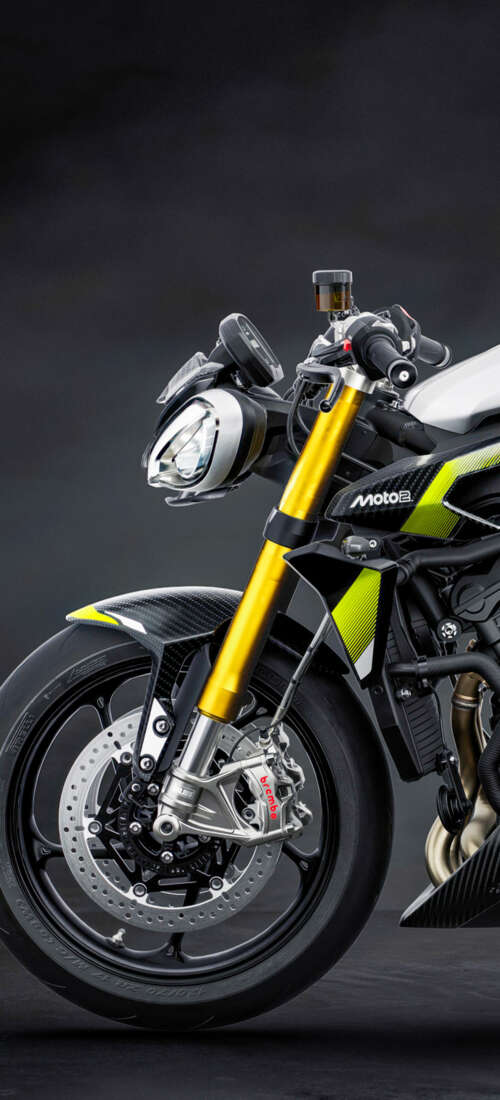 A high-performance 2026 Triumph Street Triple 765 Moto2 Edition motorcycle set against... Honor X70 wallpapers for android