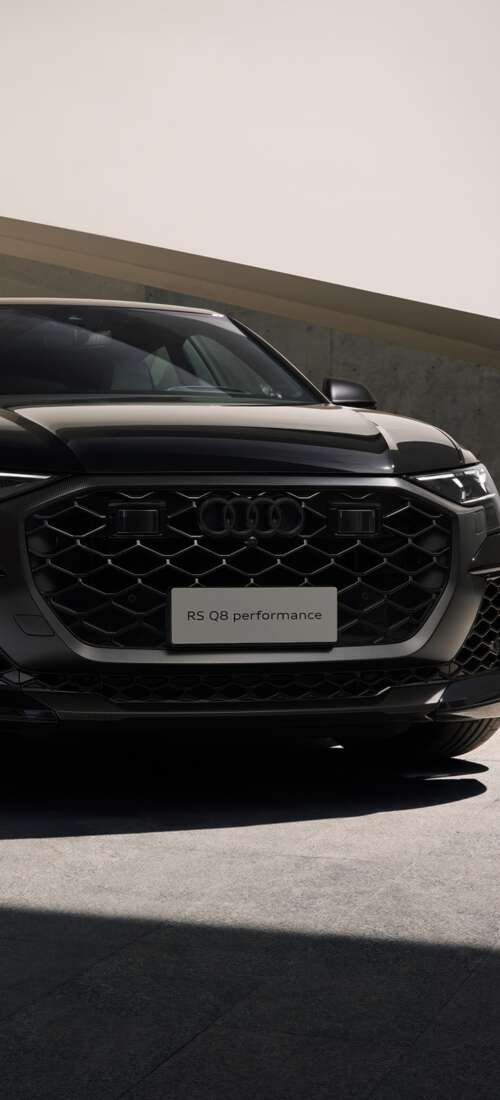 A sleek black Audi RS Q8 luxury performance SUV presented in a high-quality, cinematic... Honor X70 free wallpaper