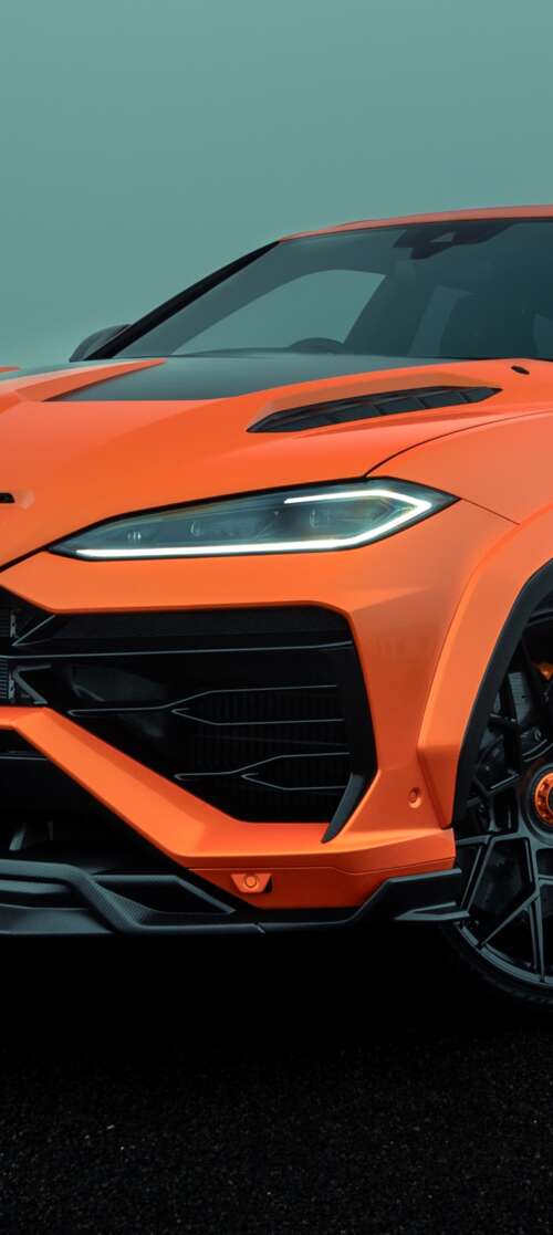 A high-resolution photograph of a Lamborghini Urus SE parked on a city street with... itel CITY 100 download free phone wallpaper