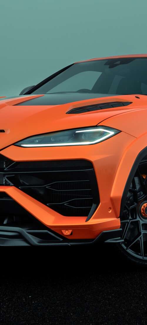 A high-resolution photograph of a Lamborghini Urus SE parked on a city street with... Honor X70 lock screen wallpaper