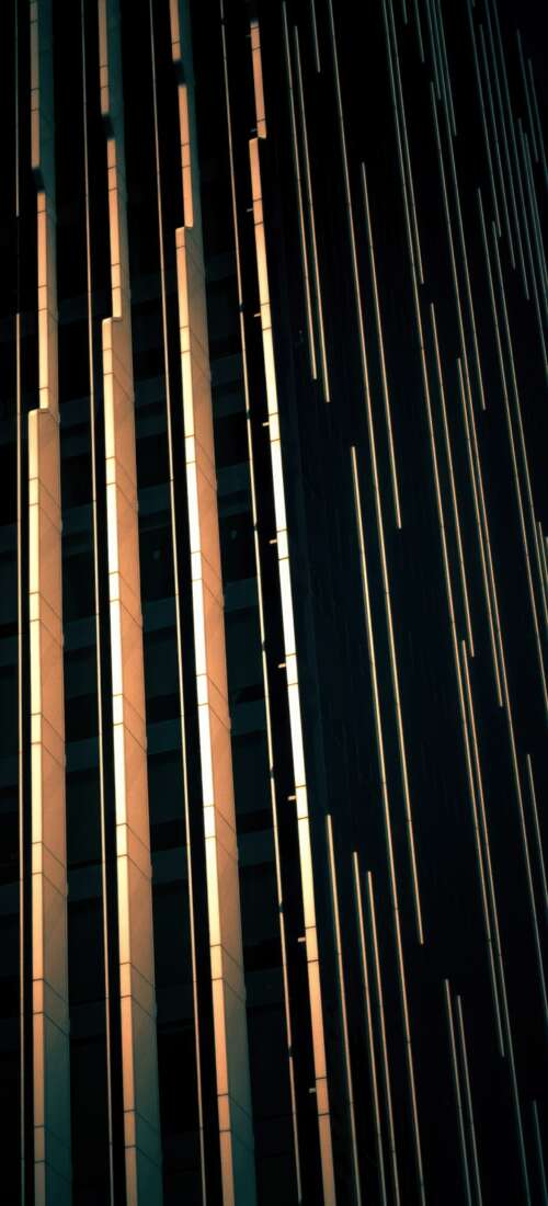 A dark, modern glass building in Abu Dhabi showcasing contemporary architectural... Honor X70 background images hd