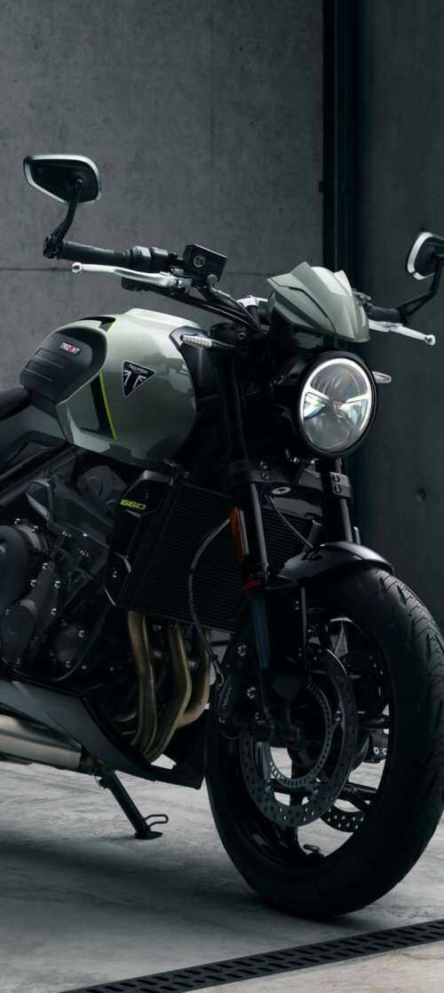 A muscular black Triumph Trident 660 street motorcycle with a sleek, modern design. itel CITY 100 free background images