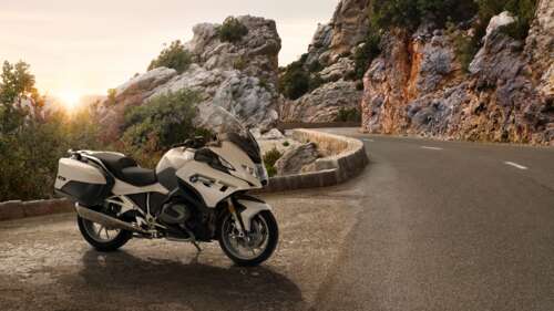 A high-resolution close-up of a modern 2024 touring motorcycle with premium finishes... wallpaper