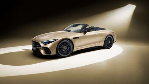 A luxurious 2025 Mercedes-AMG SL 63 4MATIC in a striking golden finish, highlighting... wallpaper