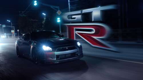 A Nissan GT-R R35 speeding through a neon-lit urban street during a night race. wallpaper
