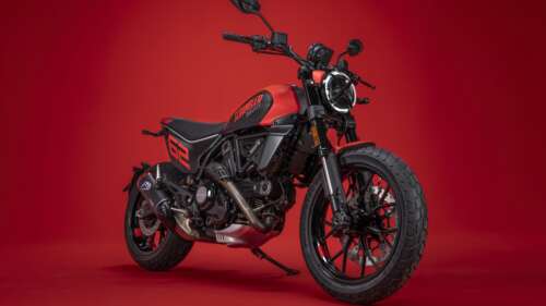 A 2023 Ducati Scrambler Full Throttle motorcycle positioned against a solid, vibrant... wallpaper images