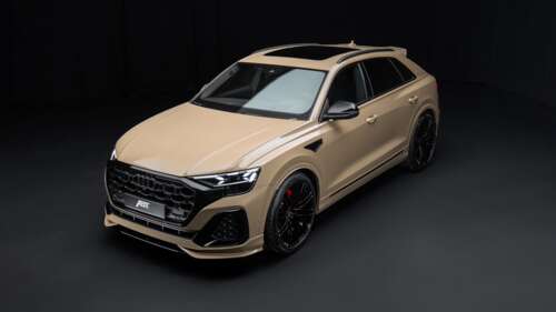 A high-resolution shot of a 2024 Audi Q8 luxury SUV featuring dramatic lighting against... free hd wallpapers