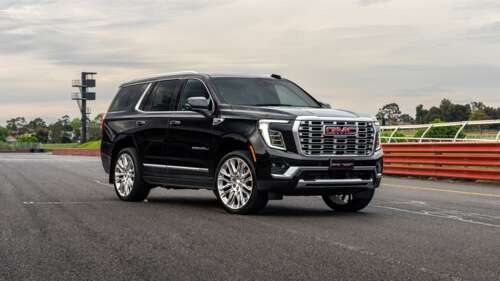 A sleek 2024 GMC Yukon Denali luxury SUV featuring premium chrome accents and a modern,... wallpaper