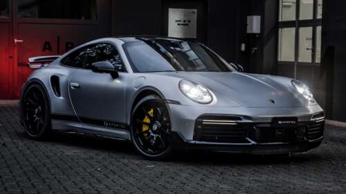 A detailed, high-resolution shot of a 2024 Porsche 911 Turbo S showcasing its aerodynamic... wallpaper images