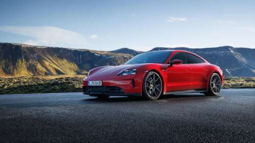 A sleek, bright red 2024 Porsche Taycan GTS electric sports car featuring a modern... wallpaper