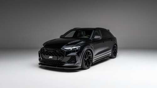 A sleek, black 2025 ABT Audi RS Q8 Legacy Edition luxury SUV parked in a premium... wallpaper