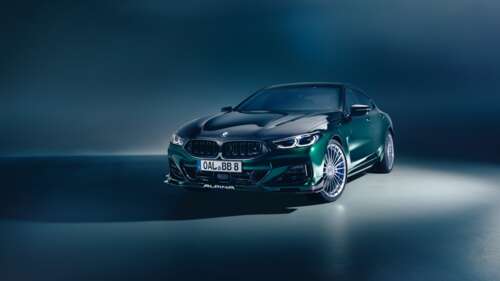 A sleek and futuristic 2025 BMW 8 Series luxury coupe with polished metallic surfaces... wallpaper