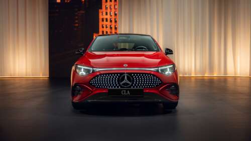 A sleek and glossy red 2025 Mercedes-Benz CLA 350 4MATIC with AMG line styling. wallpaper