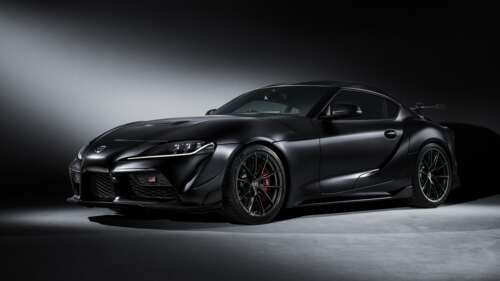 A sleek, glossy black 2025 Toyota GR Supra A90 positioned against a dark, moody background. wallpaper