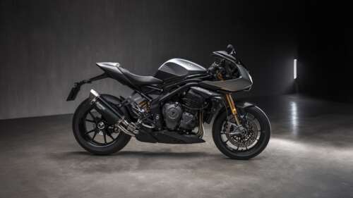 A high-resolution, close-up shot of the 2025 Triumph Speed Triple motorcycle featuring... wallpaper