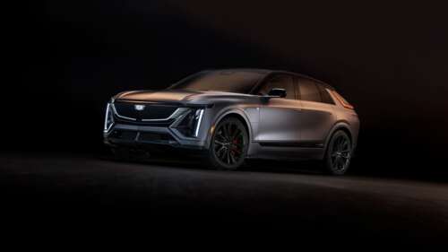 A sleek 2026 Cadillac Lyriq-V electric SUV presented in a high-contrast, dark setting. wallpaper