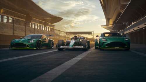 An Aston Martin Vantage GT3 sports car speeding through a corner on a professional... wallpaper