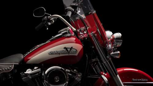 A detailed, high-contrast close-up of a vintage Harley-Davidson Hydra-Glide motorcycle... wallpaper