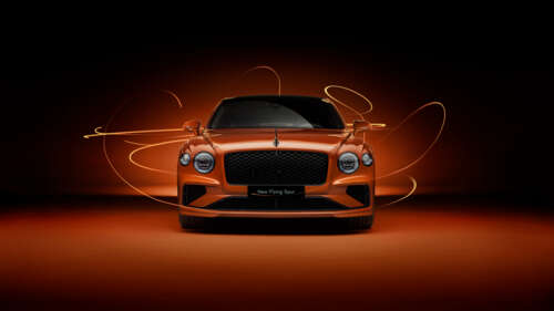 A luxury Bentley Flying Spur automobile featuring a vibrant orange aesthetic and... wallpaper