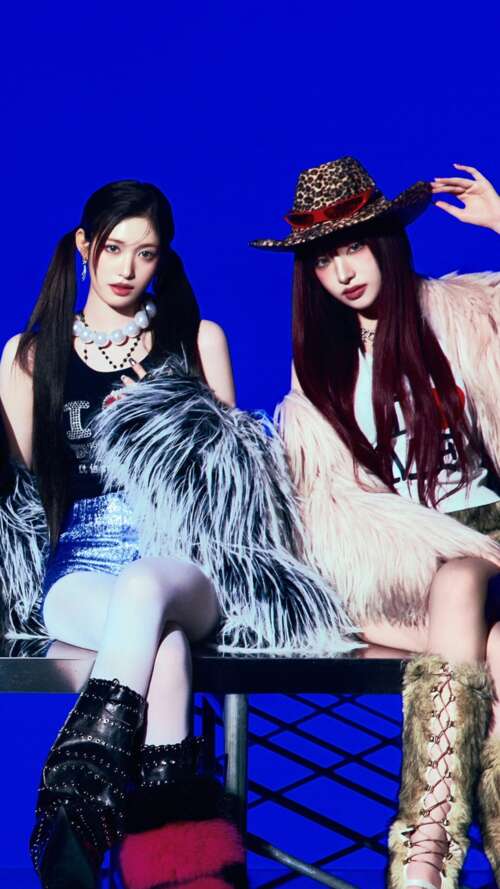 Members of the K-pop group IVE posing against a bright blue studio background in... free wallpaper