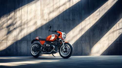 Detailed close-up of a retro-style cafe racer motorcycle with chrome finishes and... wallpaper
