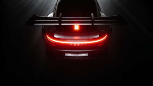 Rear view of a Porsche 911 GT3 RS featuring a dark aesthetic with glowing light accents... wallpaper