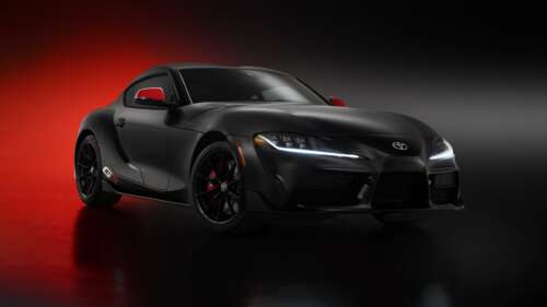 A collection of polished black cars in a dark, cinematic setting with a futuristic... wallpaper
