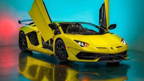 A vibrant yellow Lamborghini Aventador SVJ supercar captured in a vertical orientation. wallpaper