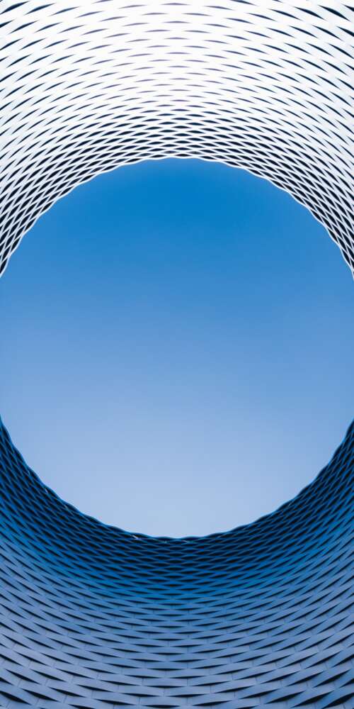 An aerial drone perspective of the modern spiral architecture of the Basel exhibition... download free phone wallpaper