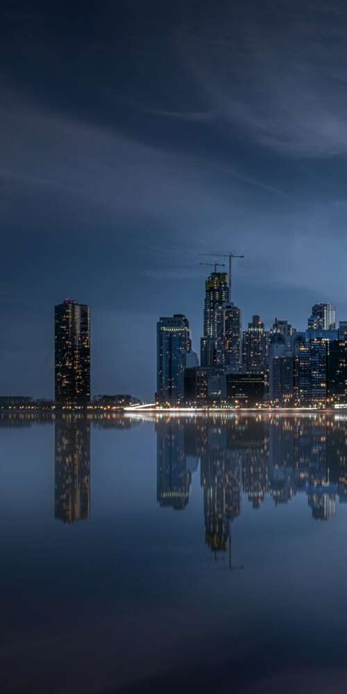 A dramatic night view of the Chicago skyline with illuminated skyscrapers and vibrant... background images hd