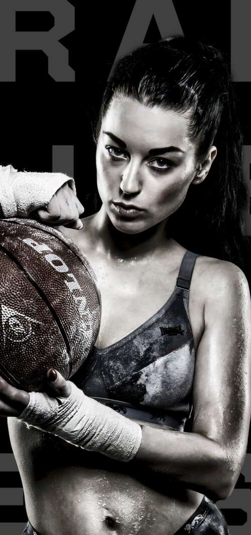 A powerful black and white close-up of an intense female basketball player looking... free background