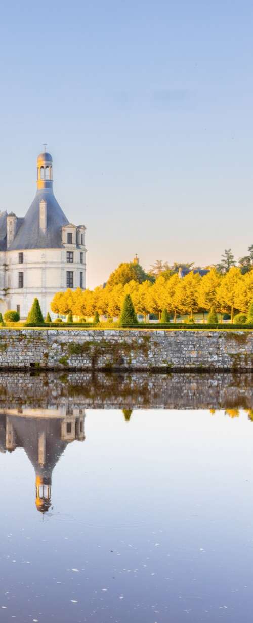 Sunlight reflecting off ancient stone buildings in France during a clear daytime. wallpaper