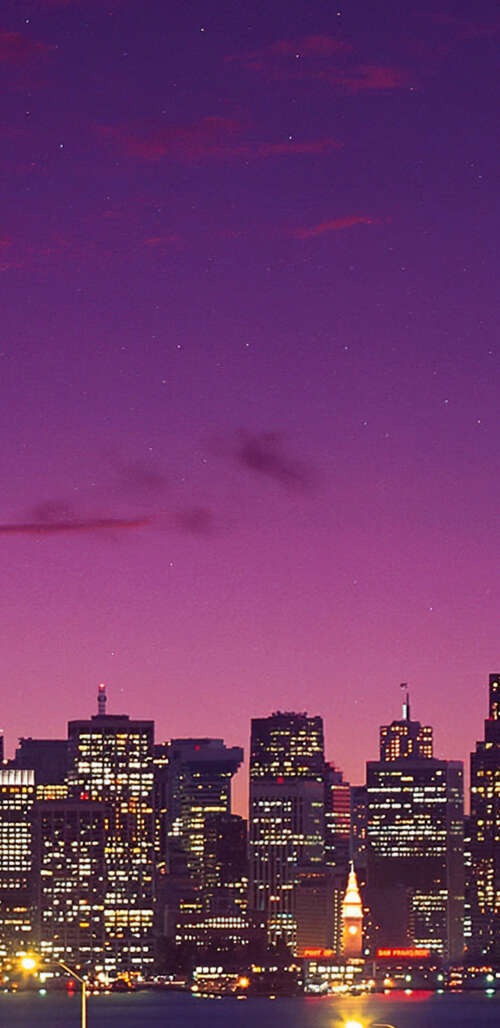 Long exposure shot of the San Francisco-Oakland Bay Bridge under a purple gradient... wallpaper