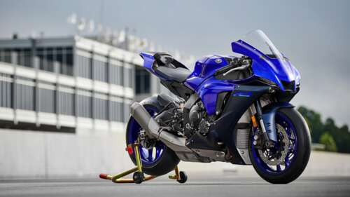 A sleek 2022 Yamaha YZF-R1 sports motorcycle displaying its aerodynamic design and... free background