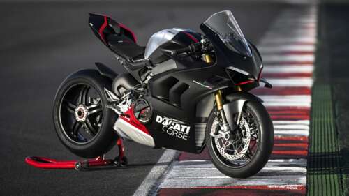 A 2023 Ducati Panigale V4 SP2 sports motorcycle parked on a professional race track. high definition wallpaper